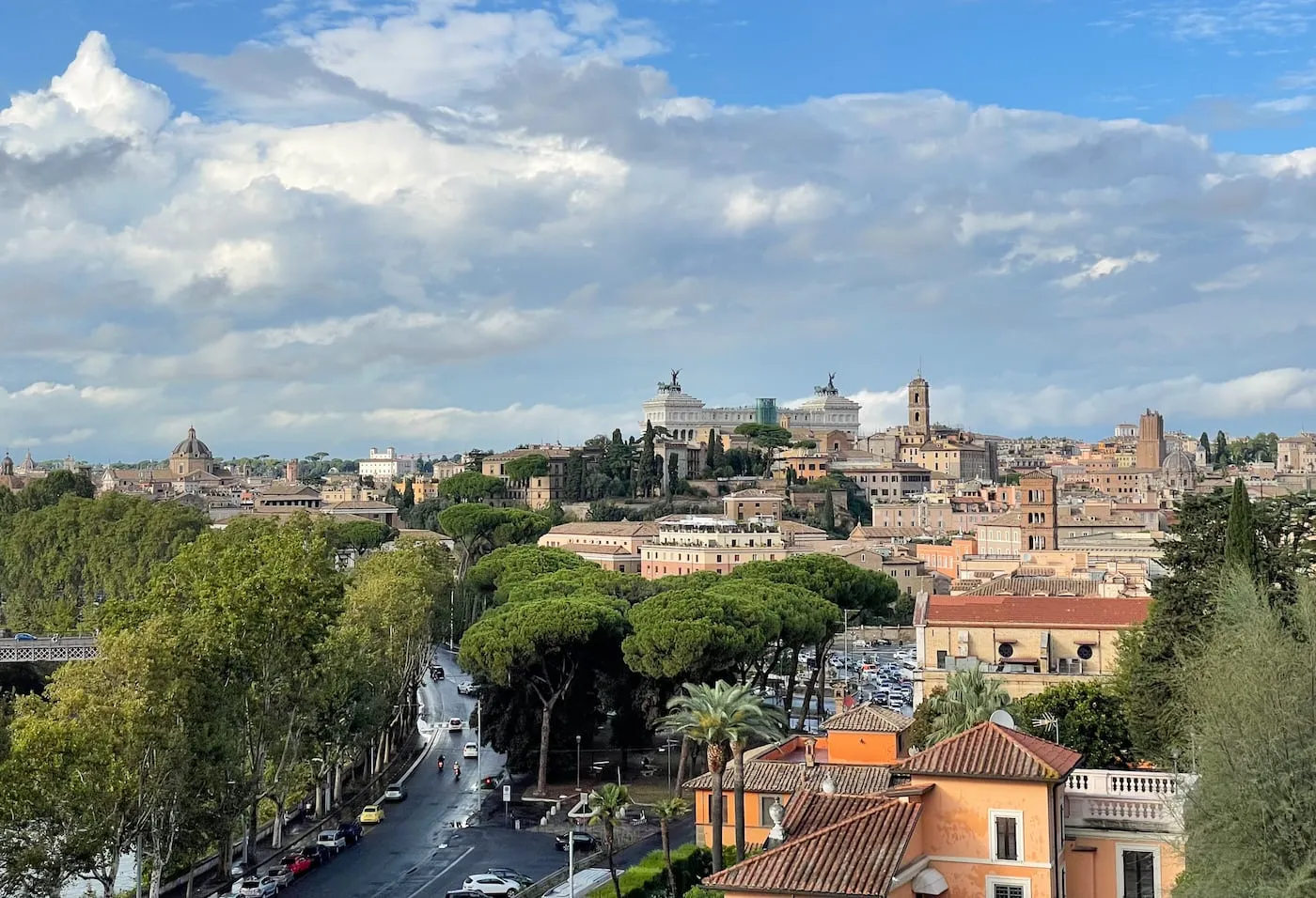 A quiet tree-lined street on the Aventine Hill, with glimpses of terracotta rooftops